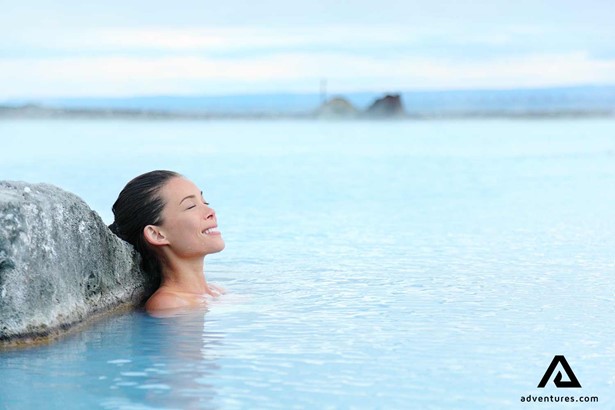 happy woman enjoying the blue lagoon in reykjanes peninsula