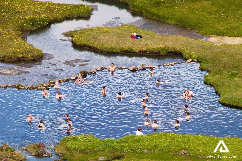 people bathing in a geothermal hot spring