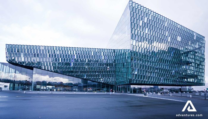 glass harpa building in reykjavik near a harbor