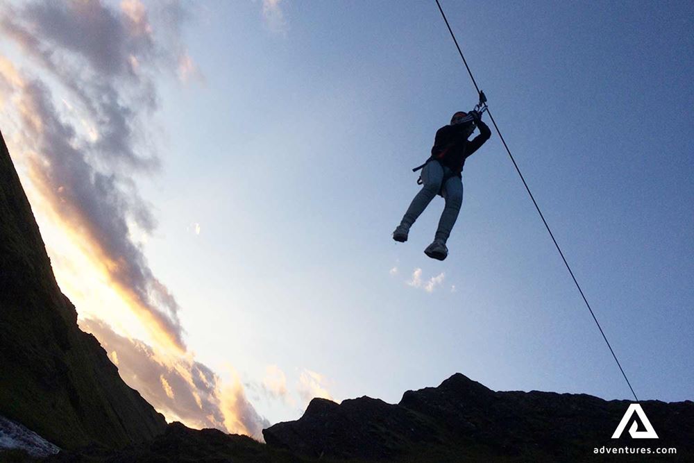 going down with a zipline at sunset