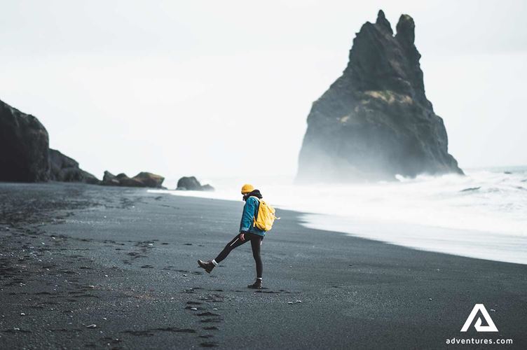 man walking around reynisfjara man walking around reynisfjara black sand beach