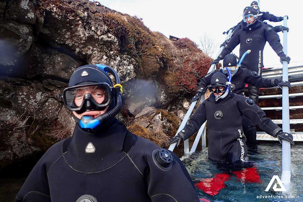 small group going into the water in Silfra