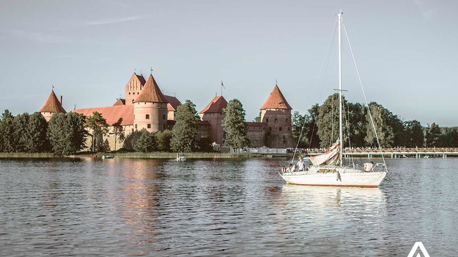 small yacht sailing near trakai castle