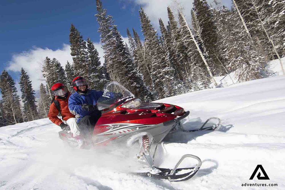 two people on a fast snowmobile