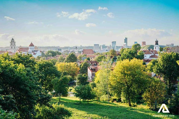 a glance of vilnius old town near trees in summer