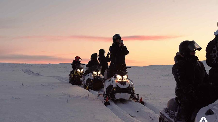 snowmobiling at sunset