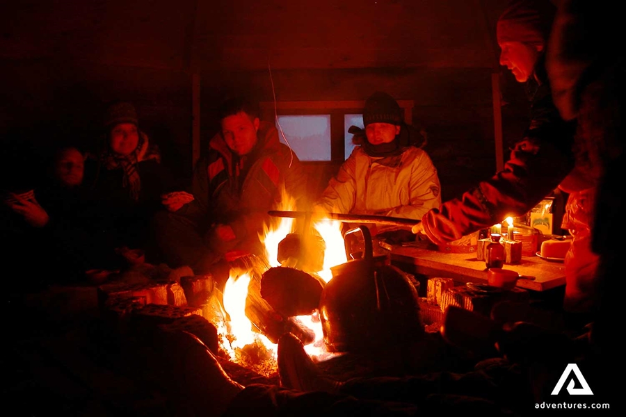 group cooking food on a campfire