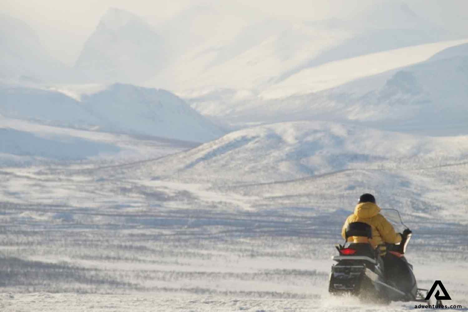 snowmobiling near mountains in sweden