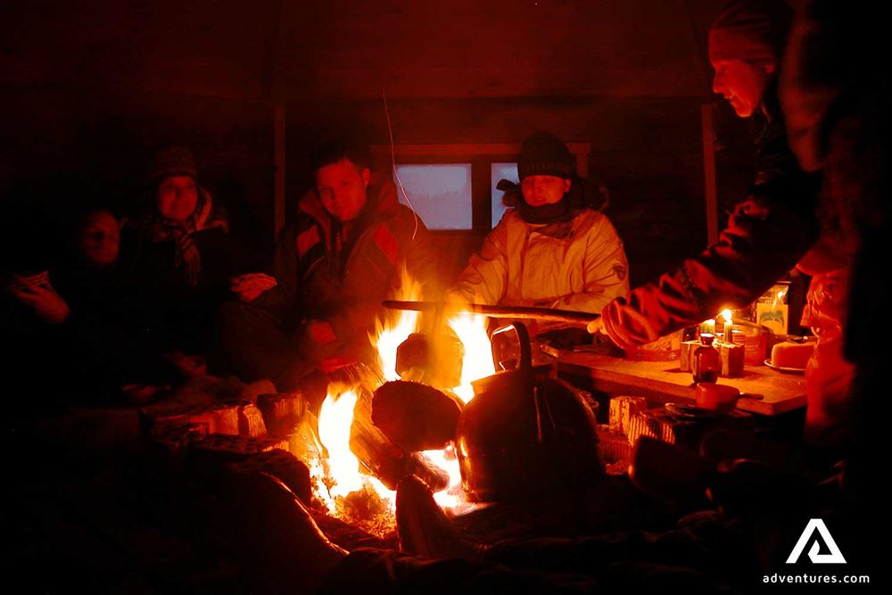 group cooking on a campfire