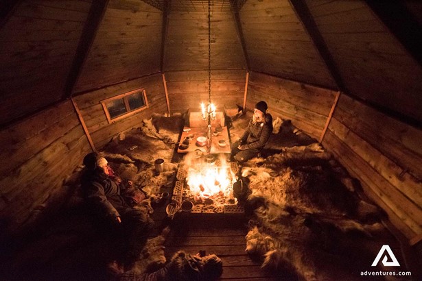 group resting in a cabin near a fireplace