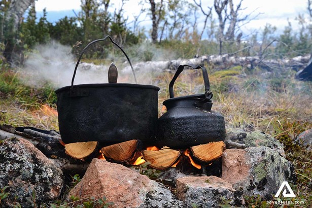 cooking with big pots on a campfire in sweden