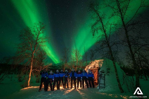 group pictures with northern lights in the background