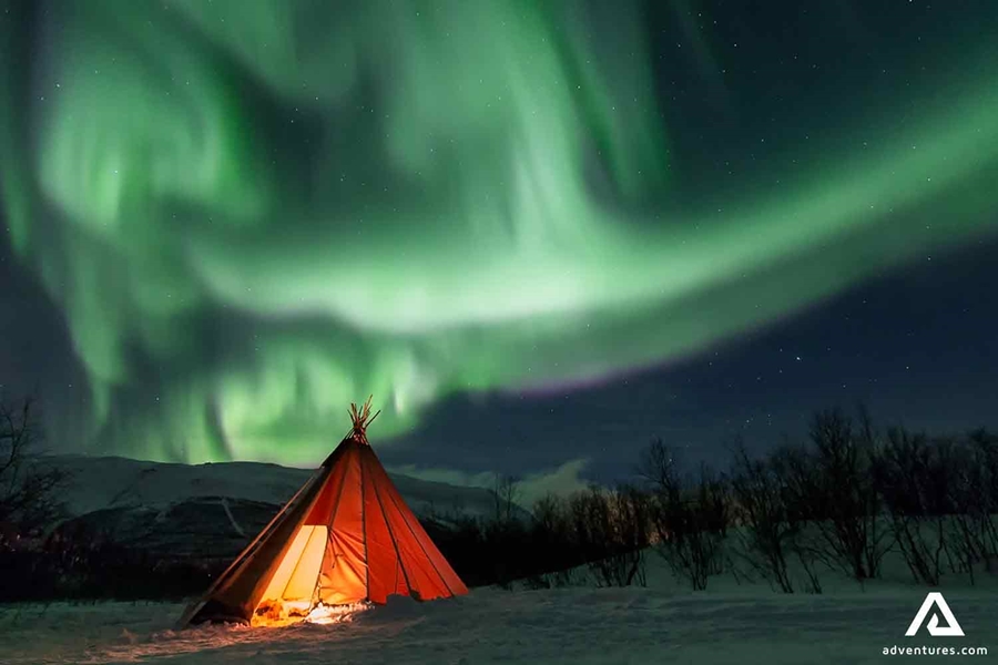 northern lights above a teepee