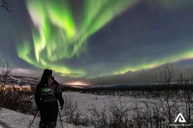 photographer watching northern lights in lapland