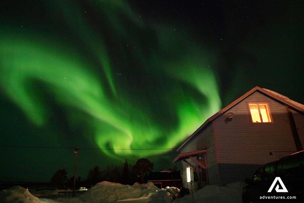 aurora borealis above a house in lapland sweden