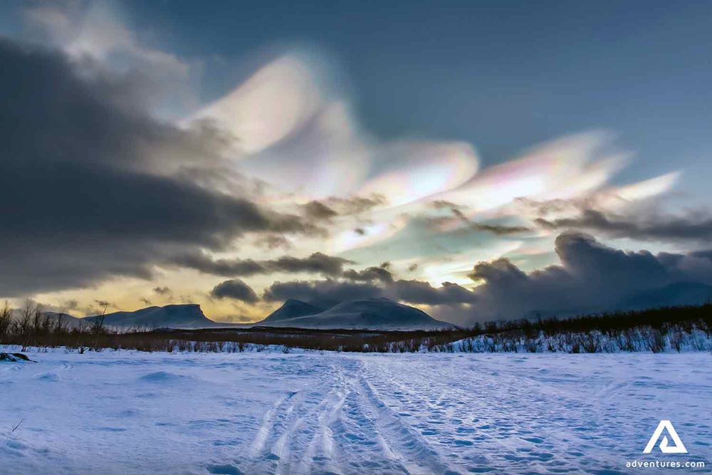 rainbow cloud above a frozen lake