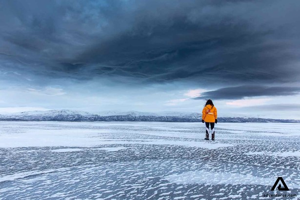 woman standing in an empty snowy field in lapland