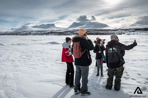 small group in abisko national park at winter near tornetrask lake