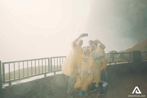 family with yellow raincoats taking a selfie
