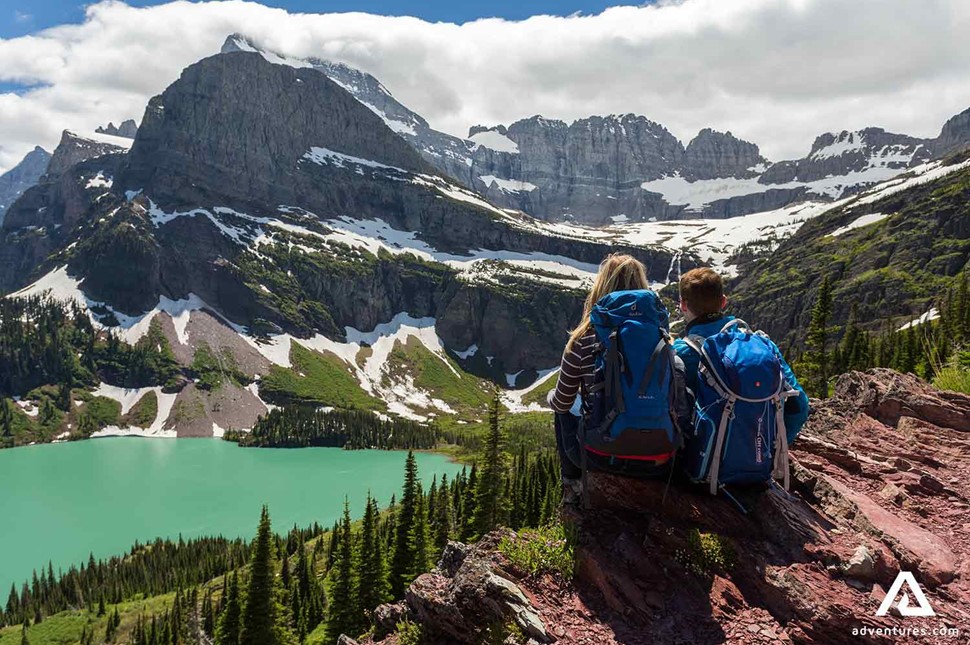 couple resting after hiking the canadian rockies in summer