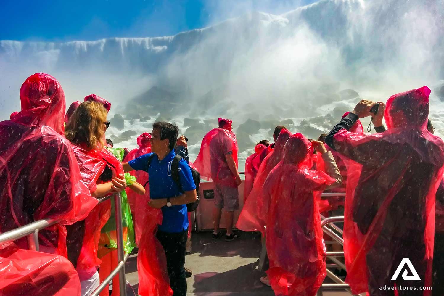 group with raincoats in a boat near niagara