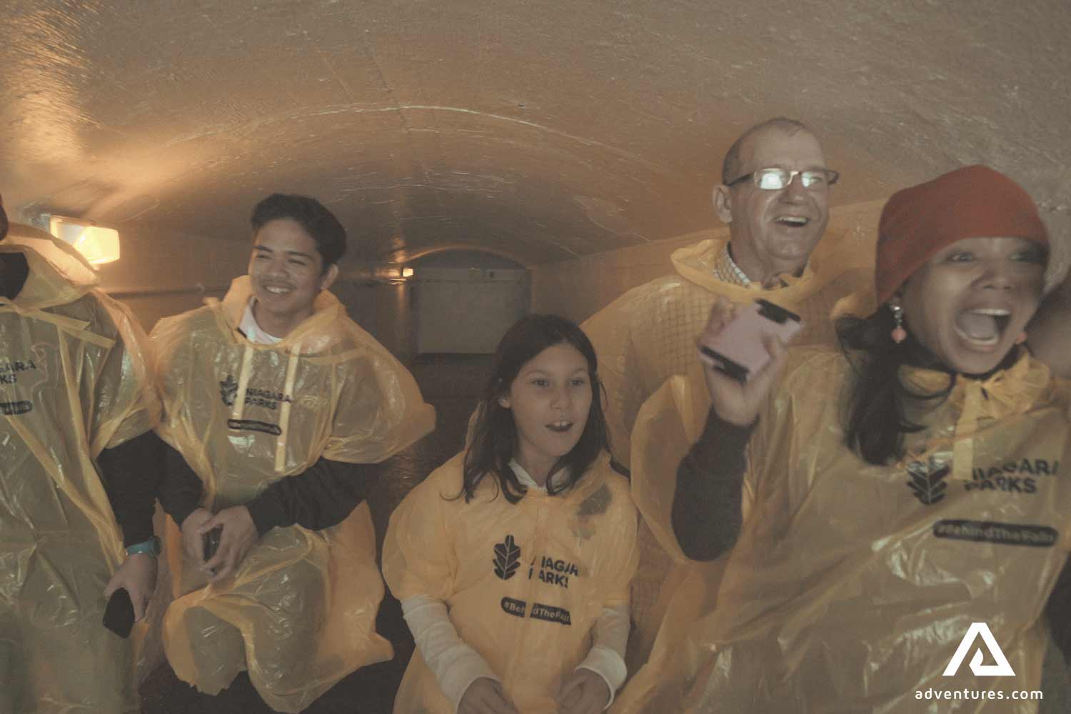 excited family in yellow raincoats near niagara falls