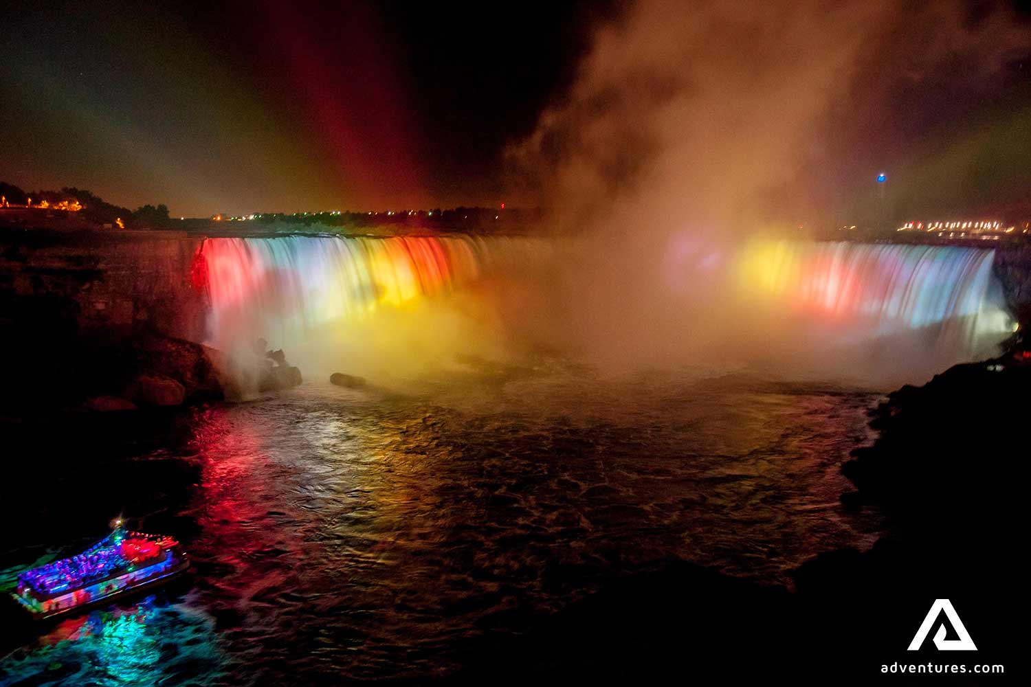 sightseeing boat approaching niagara falls at night