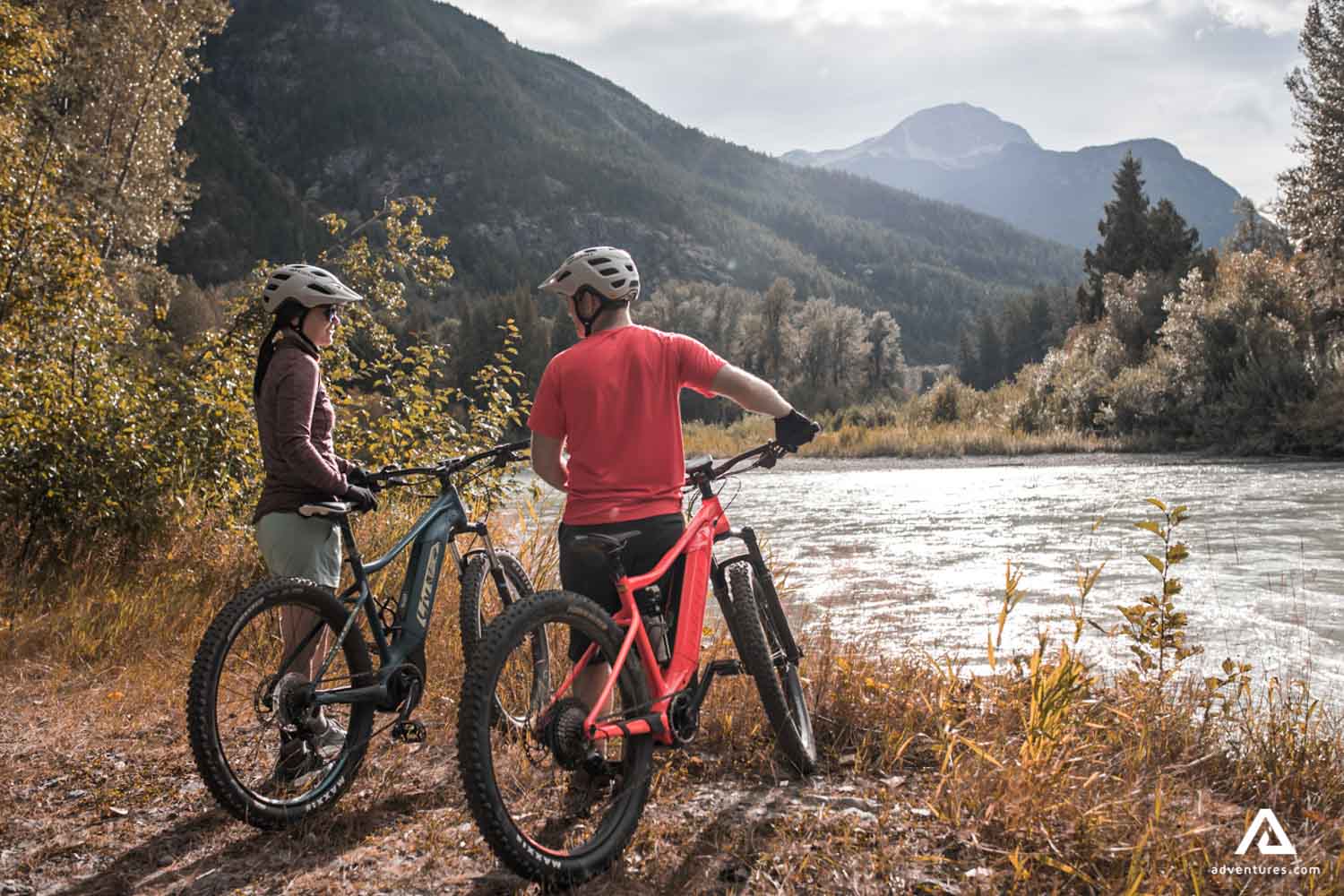 Couple with bicycles enjoying mountain view