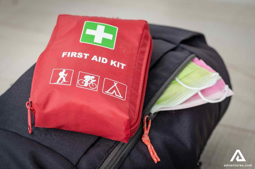 first aid kit in a backpack with face masks