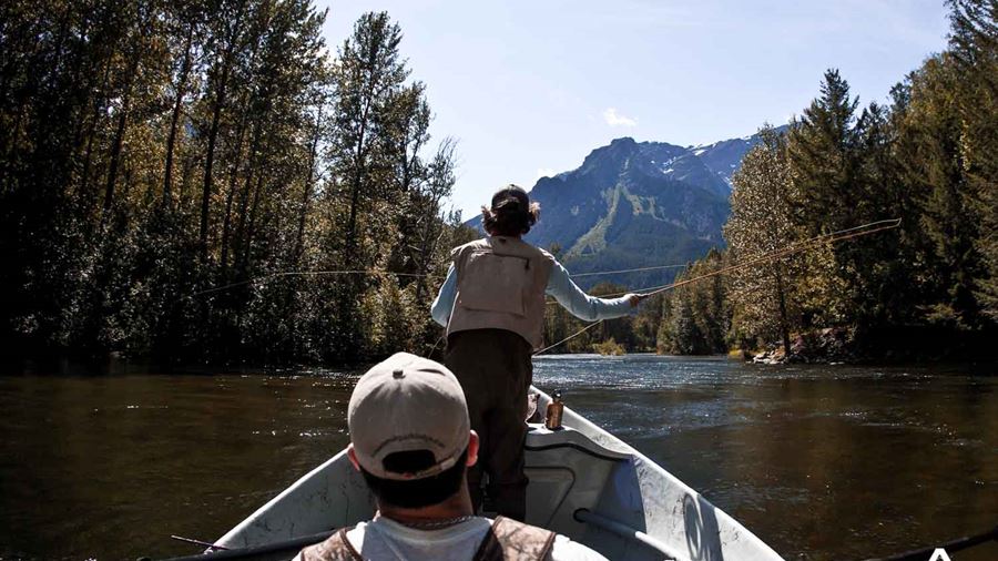 Fly fishing from the boat in forest river