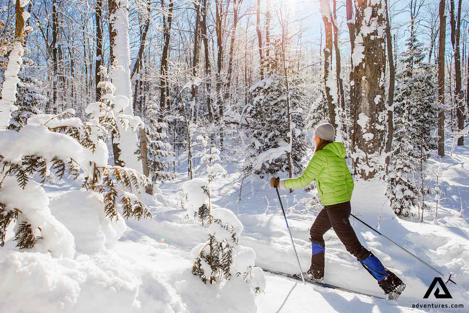 woman cross country skiing in a snowy canadian forest