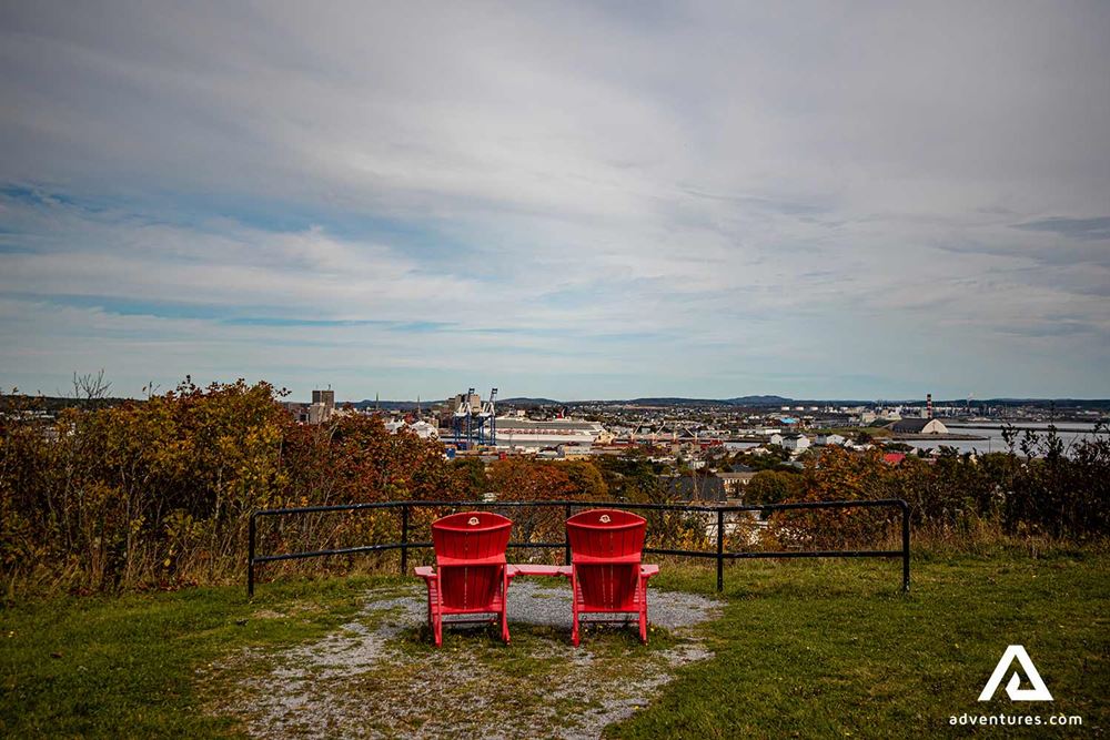 two red chairs near a viewing platform