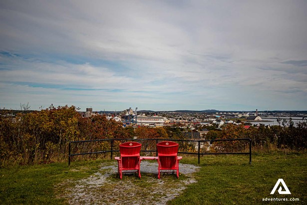 two red chairs near a viewing platform in saint john