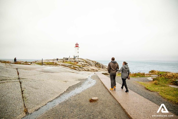 couple Walking Around Peggy Cove Lighthouse