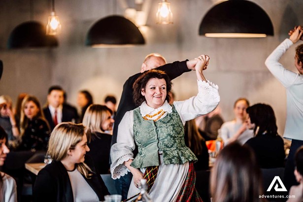 happy woman dancing with a national dress in baltics