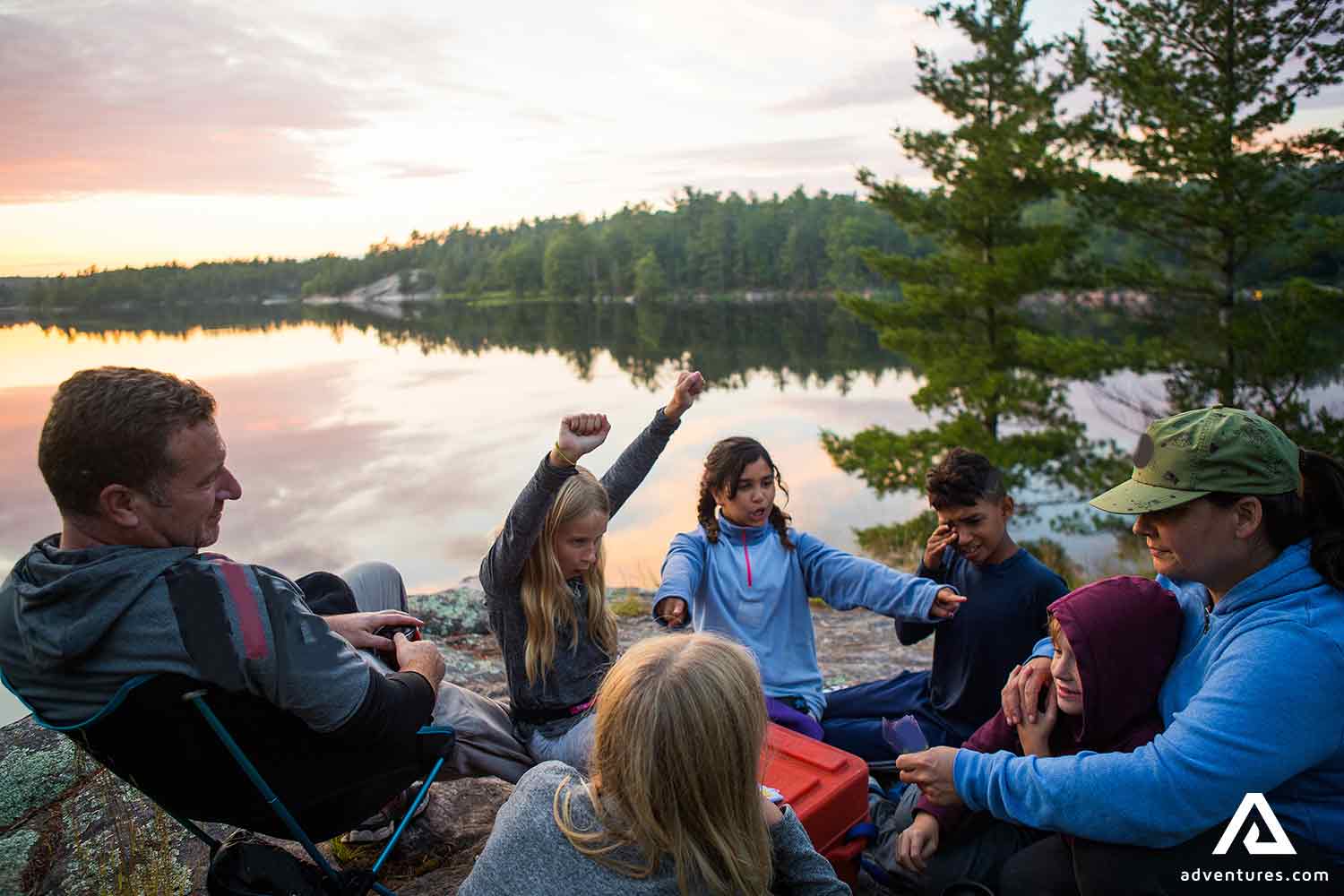 happy big family camping near a lake