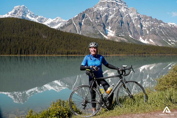 Man with a bicycle in rocky mountains
