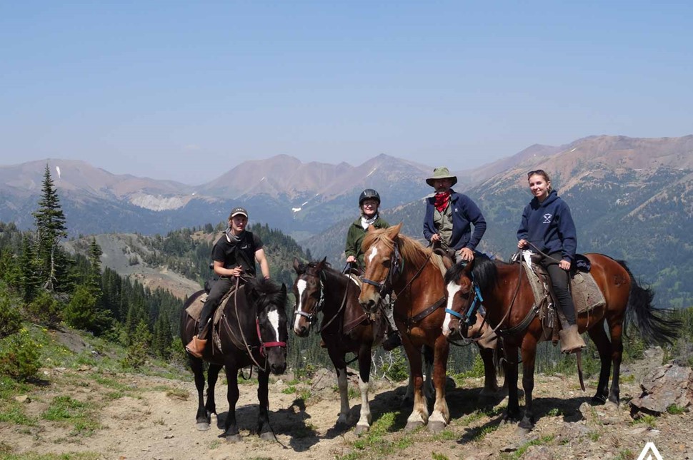Horseback riding with a mountain view
