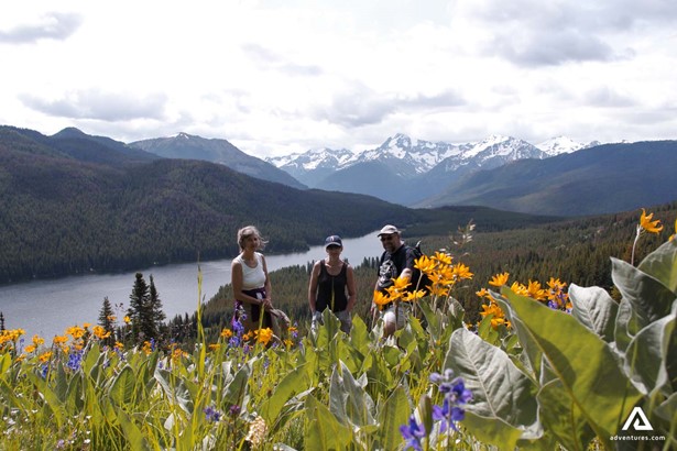 hikers in a mountain flower field in canada at summer