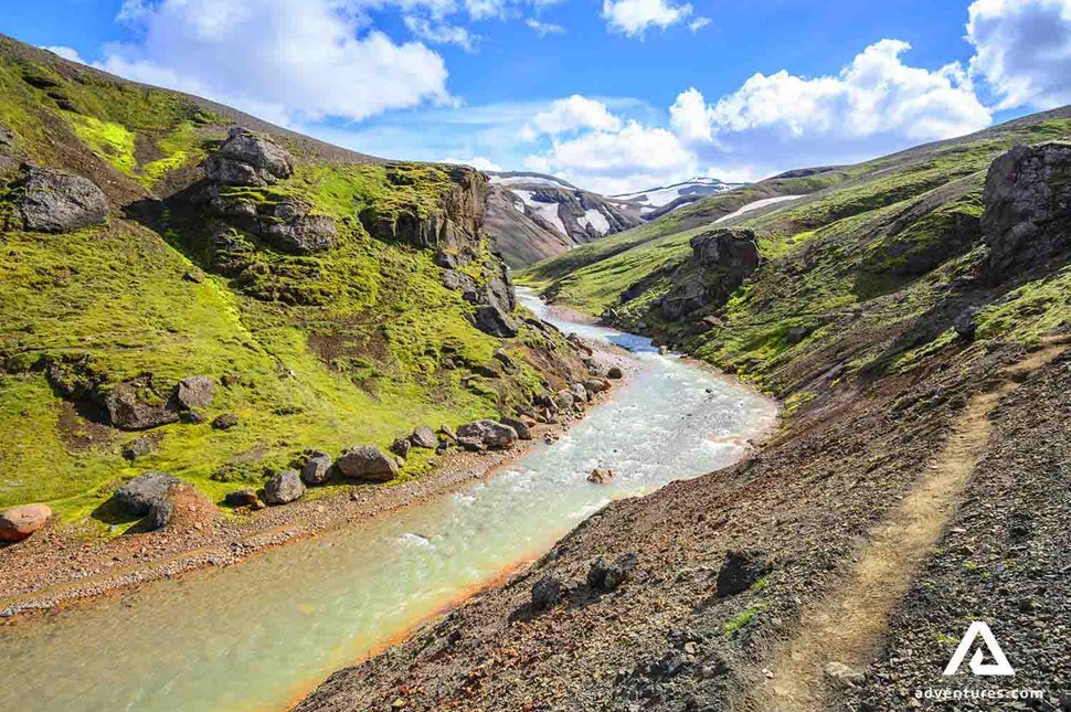 river flowing near mossy mountain sides in iceland