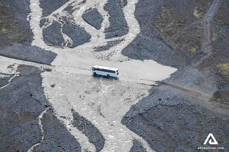 bus crossing a river in iceland