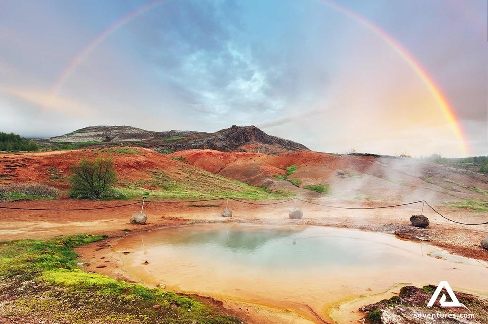 bright rainbow over geysir geothermal area