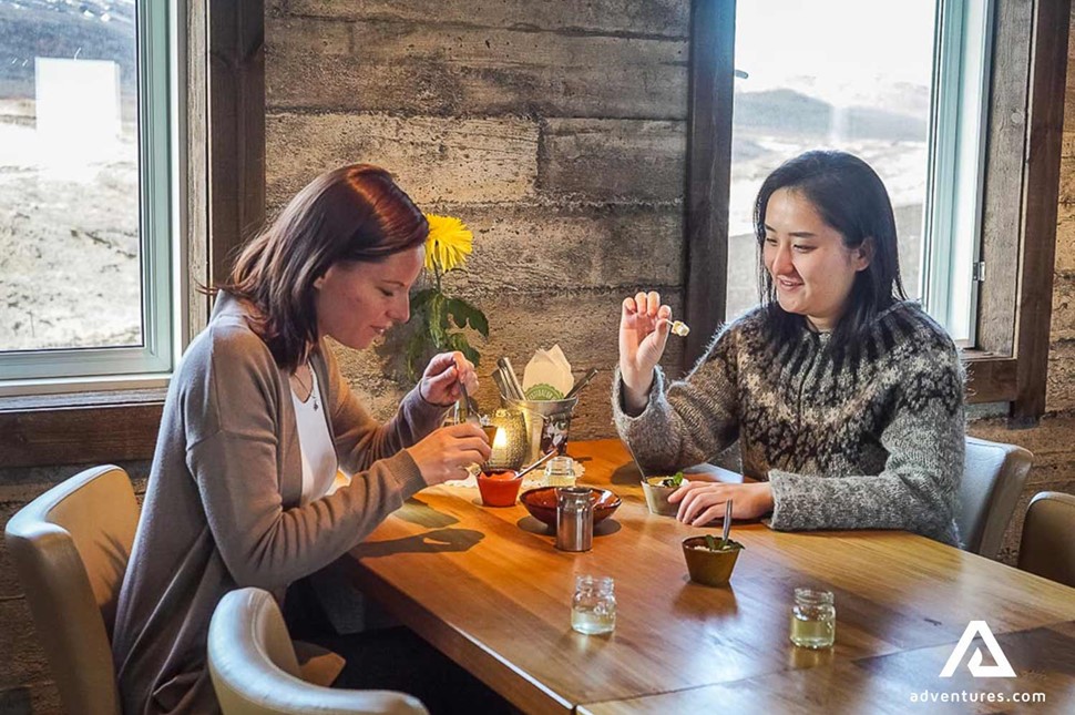 two friends tasting food in iceland