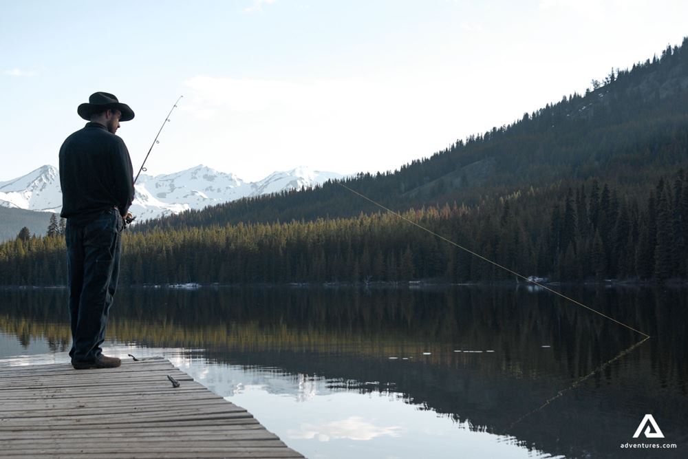 Man fishing in mountain lake