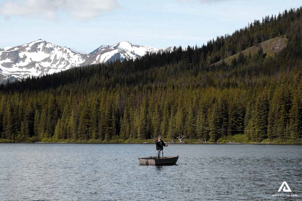 Man fishing in a lake from a boat in Canada
