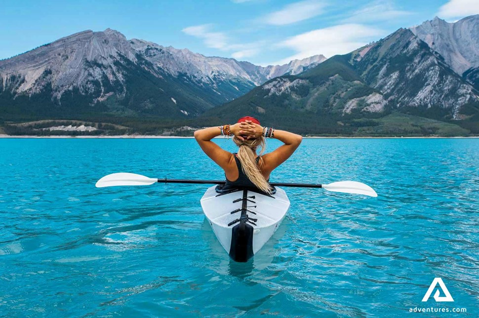 woman enjoying the view from a kayak at lake louise