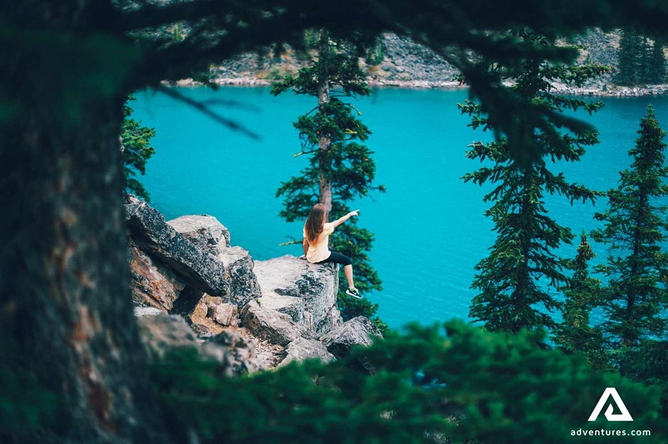 woman sitting on cliff rocks in alberta canada area