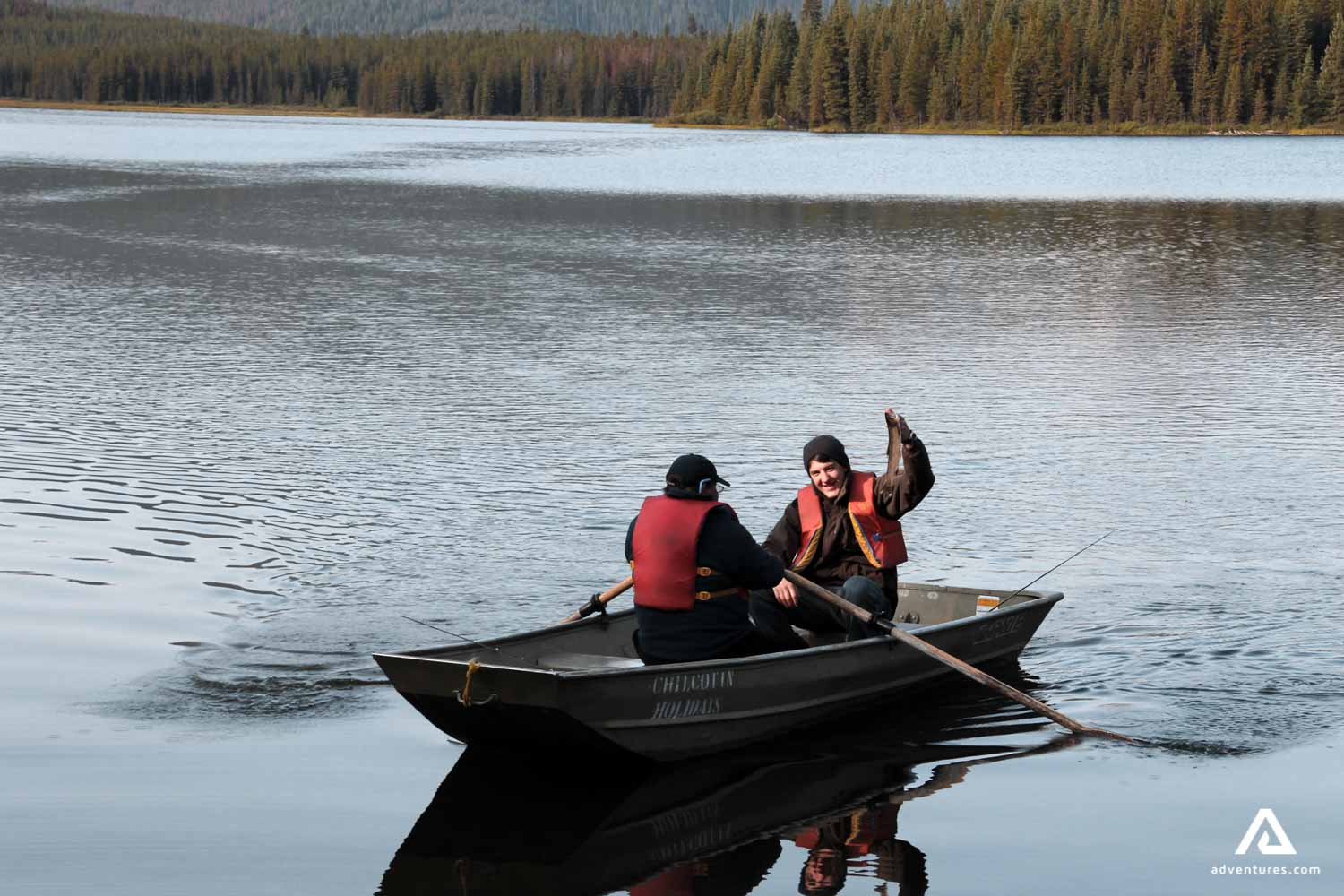 Two mid-age men fishing from a boat