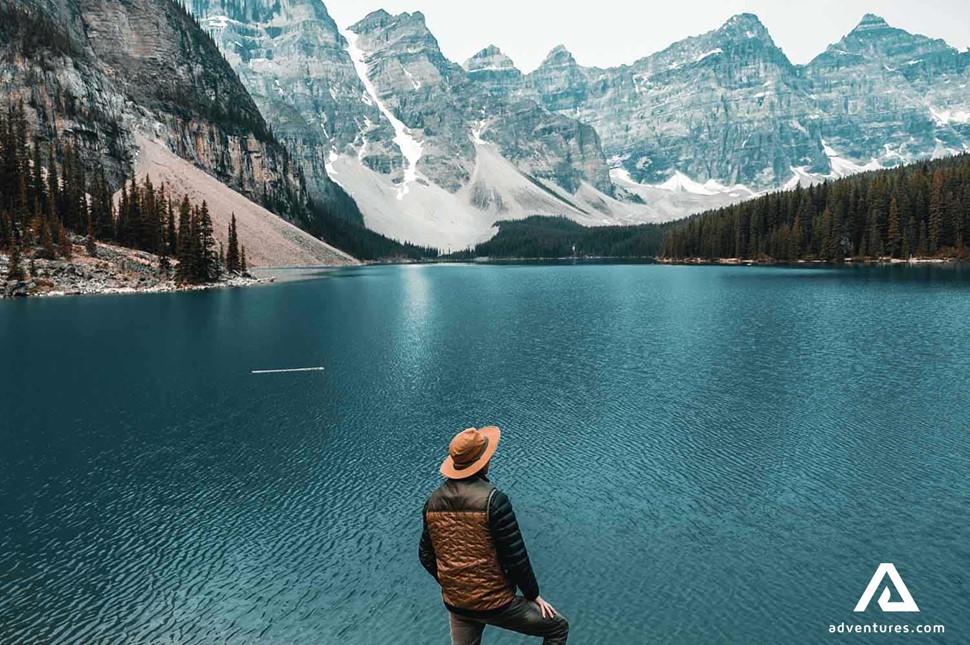 a man looking at lake louise surroundings in canada