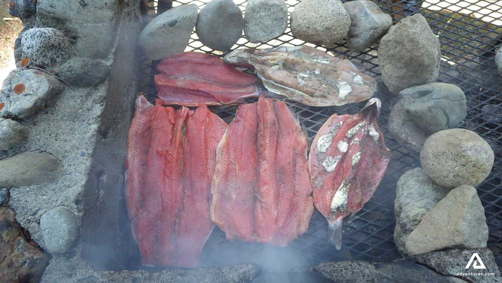 Grilled salmon fish on open fire